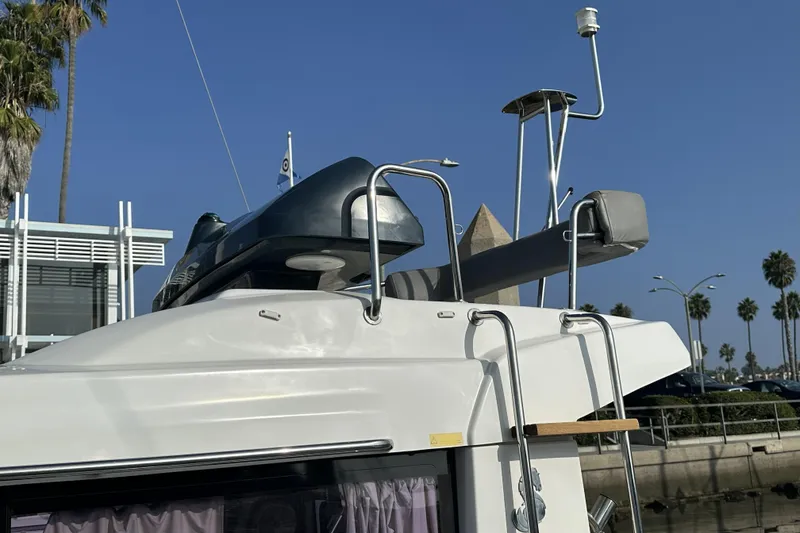 Slide: The Image of 2012 Beneteau Barracuda 9 boat with radar and equipment on roof, docked near palm trees. - 5