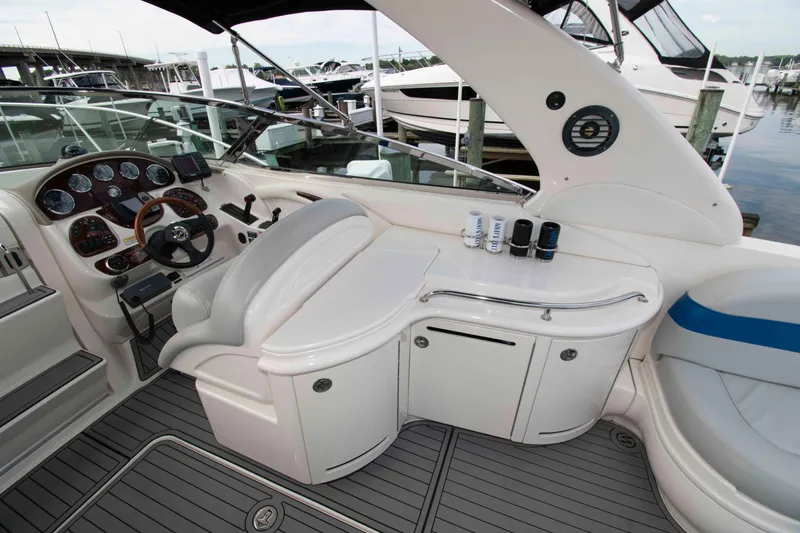 Slide: The Image of 2004 Sea Ray 290 Sun Sport boat interior with helm, seating, and control panel. - 10
