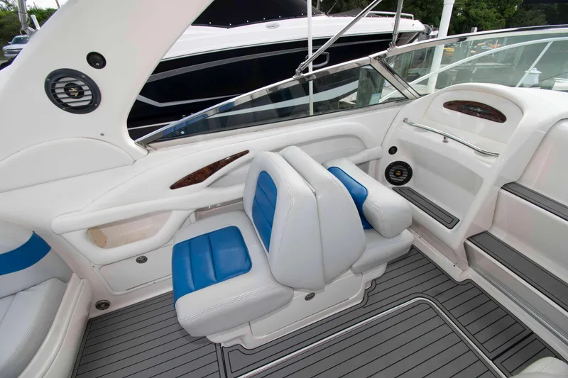 Slide: The Image of 2004 Sea Ray 290 Sun Sport boat interior with blue and white seating. - 11