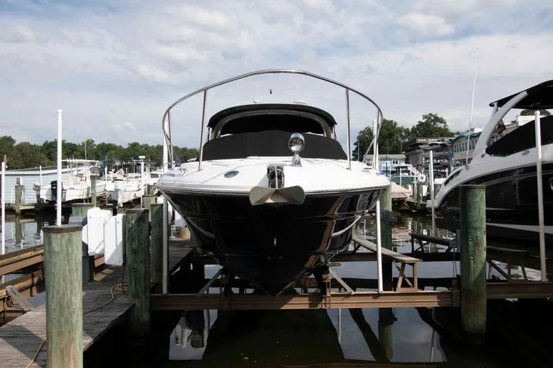 Slide: The Image of 2004 Sea Ray 290 Sun Sport docked at a marina, front view. - 3