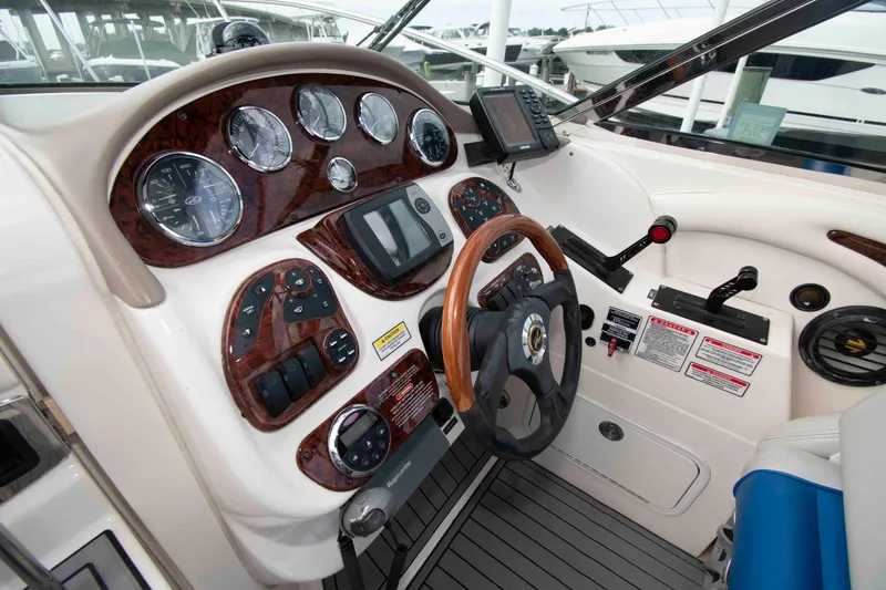 Slide: The Image of Dashboard of a 2004 Sea Ray 290 Sun Sport boat with gauges and controls. - 8