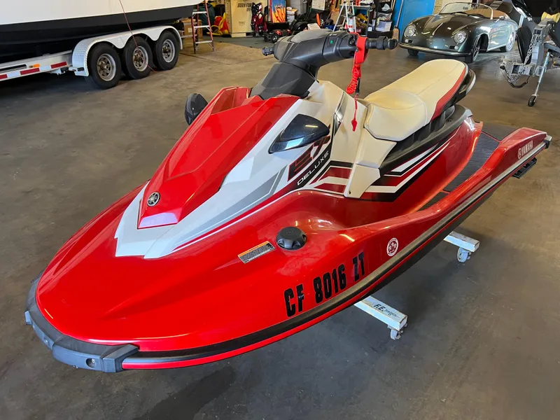 Slide: The Image of 2019 Yamaha WaveRunner EX Deluxe in red, parked indoors on a stand. - 5