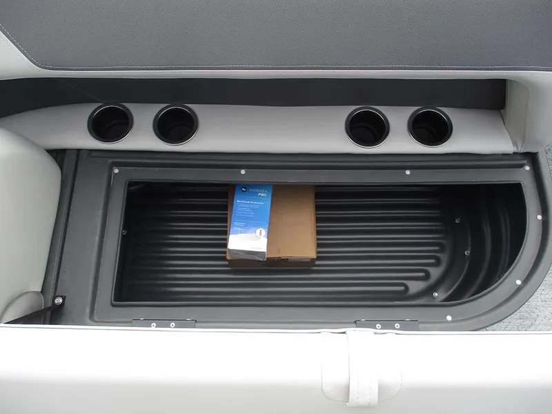 Slide: The Image of 2026 Sun Tracker Bass Buggy 16 XL Select storage compartment with cup holders and packaged items. - 15