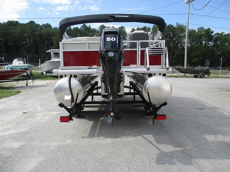 Slide: The Image of 2026 Sun Tracker Bass Buggy 16 XL Select pontoon boat with 50 HP engine, rear view. - 9