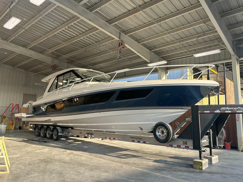 Slide: The Image of 2025 Intrepid 50 Evolution yacht on trailer in a warehouse setting. - 1