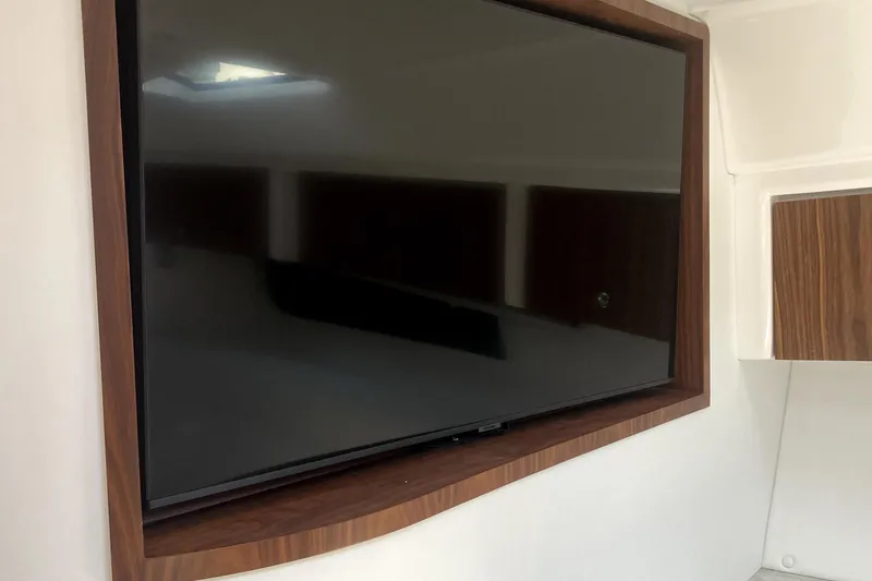 Slide: The Image of 2025 Intrepid 50 Evolution yacht with sleek white exterior and modern design. - 18