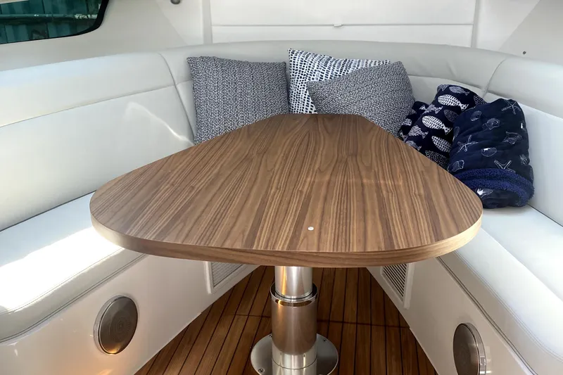 Slide: The Image of Luxurious interior of 2025 Intrepid 50 Evolution yacht with wooden table and cushions. - 19