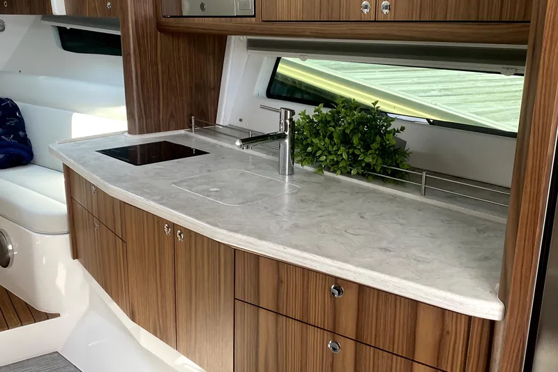 Slide: The Image of Flat-screen TV in 2025 Intrepid 50 Evolution yacht interior with wood paneling. - 20