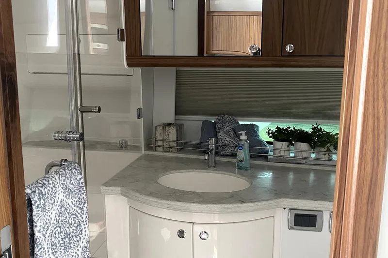 Slide: The Image of Luxurious kitchen area in 2025 Intrepid 50 Evolution yacht with sleek wood cabinetry. - 21