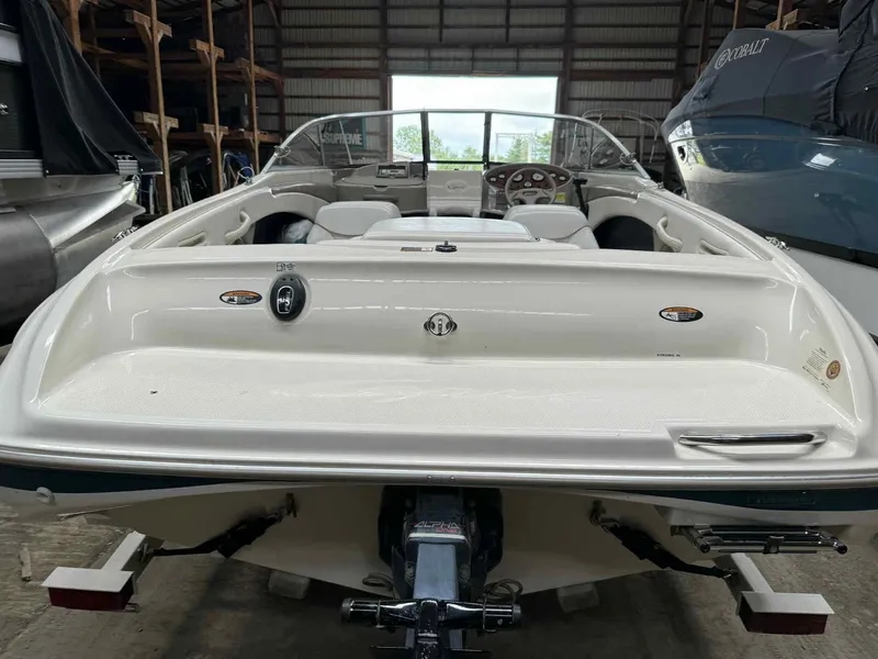 Slide: The Image of 2000 Bayliner 1750 Capri DX boat in storage, rear view showing interior and dashboard. - 10