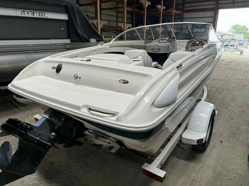 Slide: The Image of 2000 Bayliner 1750 Capri DX boat in storage, rear view, on trailer. - 11