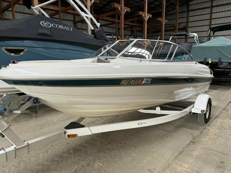 Slide: The Image of 2000 Bayliner 1750 Capri DX boat on trailer in storage facility. - 15