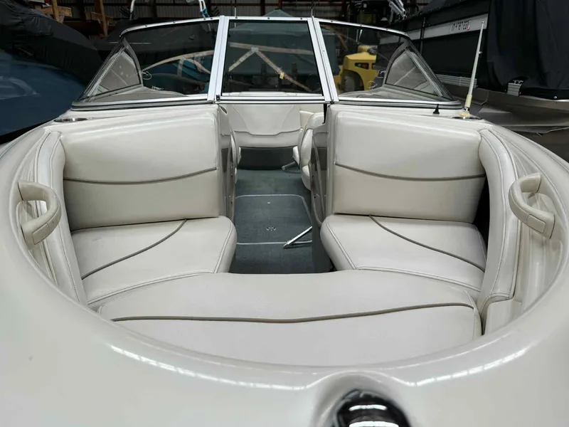Slide: The Image of Interior of 2000 Bayliner 1750 Capri DX boat with white seating and windshield. - 2