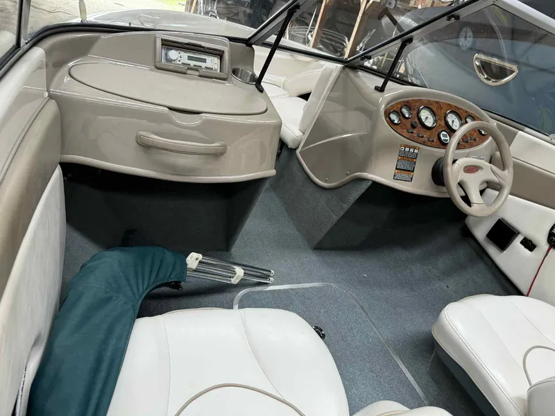 Slide: The Image of Interior of a 2000 Bayliner 1750 Capri DX boat with steering wheel and dashboard. - 4