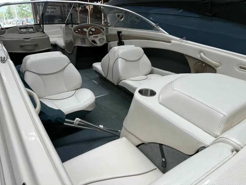 Slide: The Image of Interior of a 2000 Bayliner 1750 Capri DX boat with white seating and dashboard. - 7