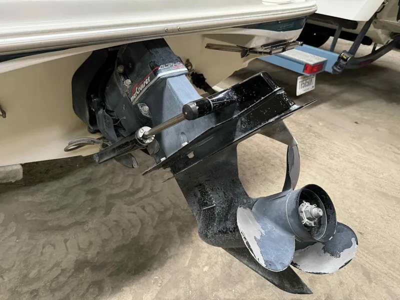 Slide: The Image of Bayliner 1750 Capri DX 2000 boat propeller and outdrive in a garage setting. - 9