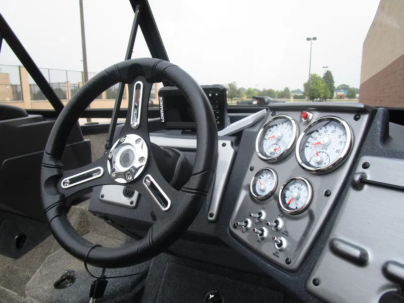 Slide: The Image of 2026 Tracker Pro Guide V175 CB boat dashboard with steering wheel and gauges. - 10