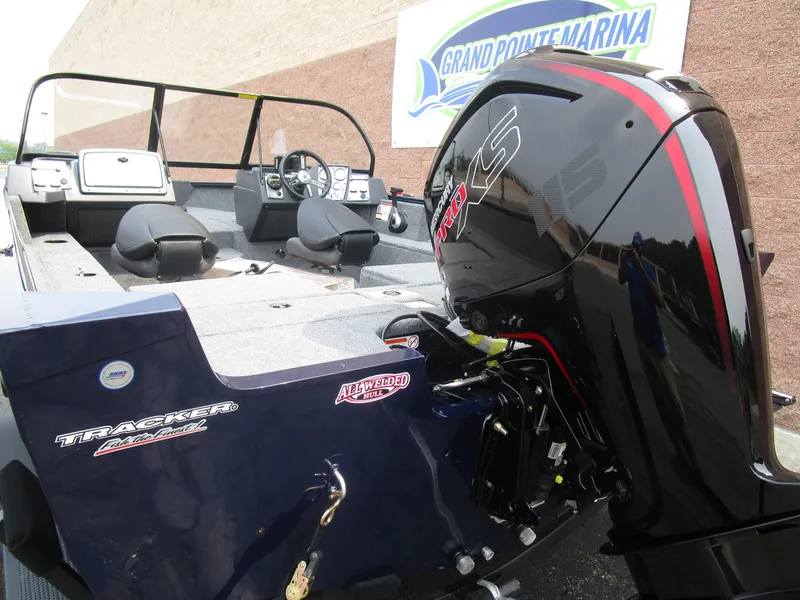 Slide: The Image of 2026 Tracker Pro Guide V175 CB boat with powerful outboard motor at Grand Pointe Marina. - 4