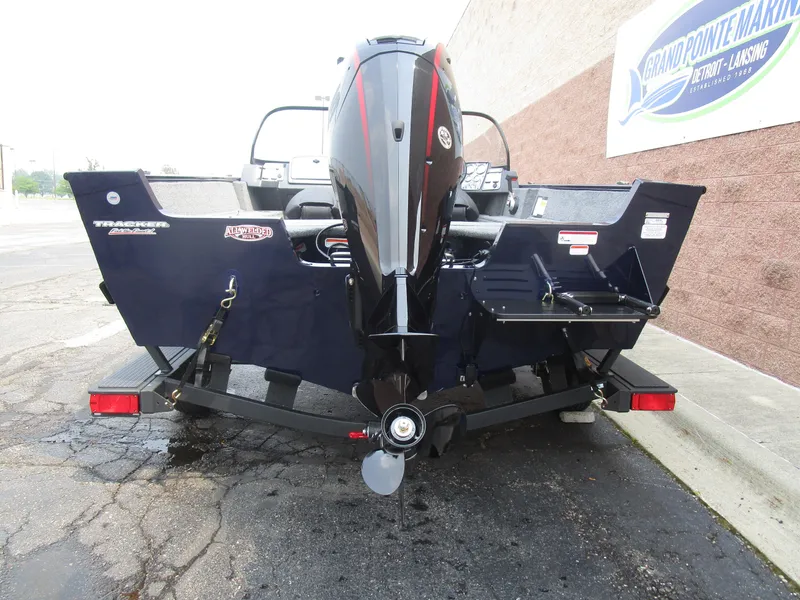 Slide: The Image of 2026 Tracker Pro Guide V175 CB boat rear view with motor, parked on trailer. - 5