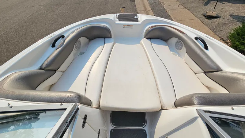 Slide: The Image of 2011 Yamaha SX210 boat interior with white and gray seating. - 10