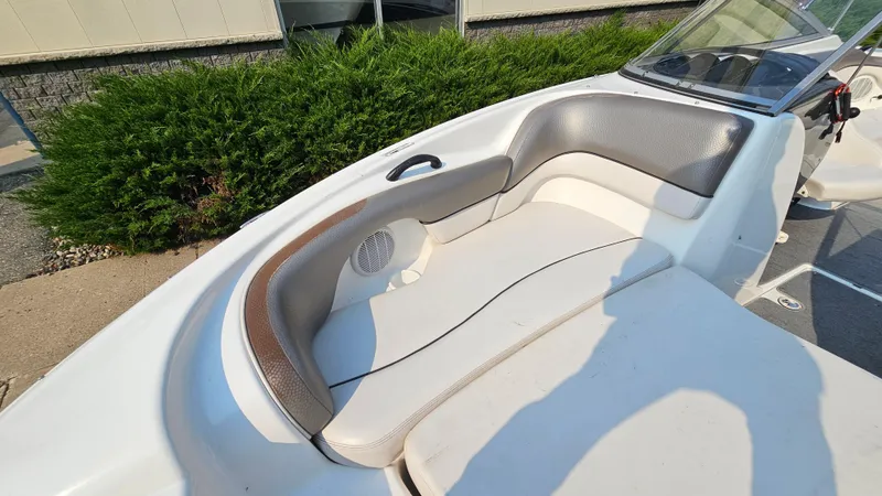 Slide: The Image of 2011 Yamaha SX210 boat interior with cushioned seating and windshield. - 13