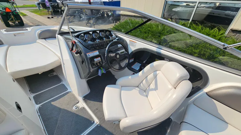 Slide: The Image of 2011 Yamaha SX210 boat interior with steering wheel and seating area. - 14