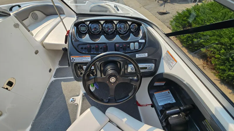 Slide: The Image of 2011 Yamaha Boats SX210 dashboard with steering wheel and control panel. - 15