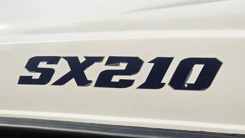 Slide: The Image of 2011 Yamaha Boats SX210 logo on white surface. - 18