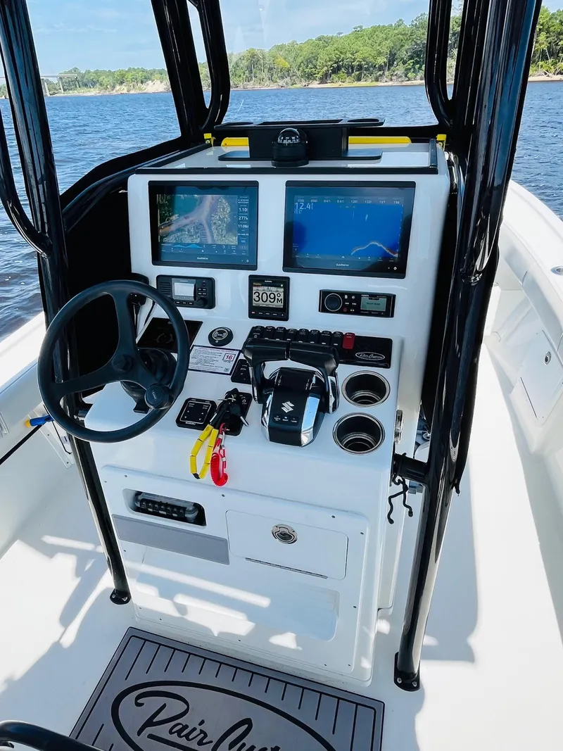 Slide: The Image of 2023 Pair Customs 24 Center Console DV boat on open water under clear blue sky. - 12