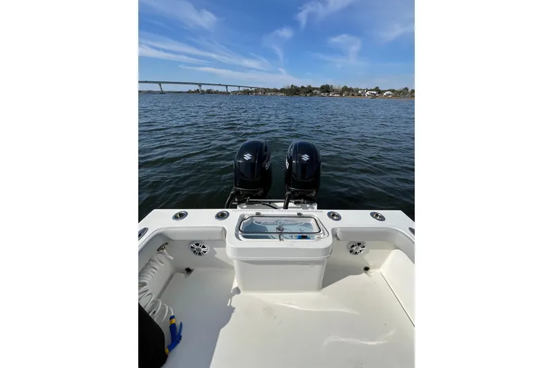 Slide: The Image of 2023 Pair Customs 24 Center Console DV boat on water, featuring dual engines. - 16