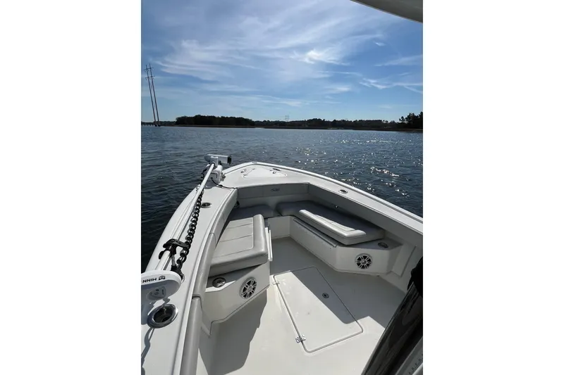 Slide: The Image of 2023 Pair Customs 24 Center Console DV boat on calm water under blue sky. - 17