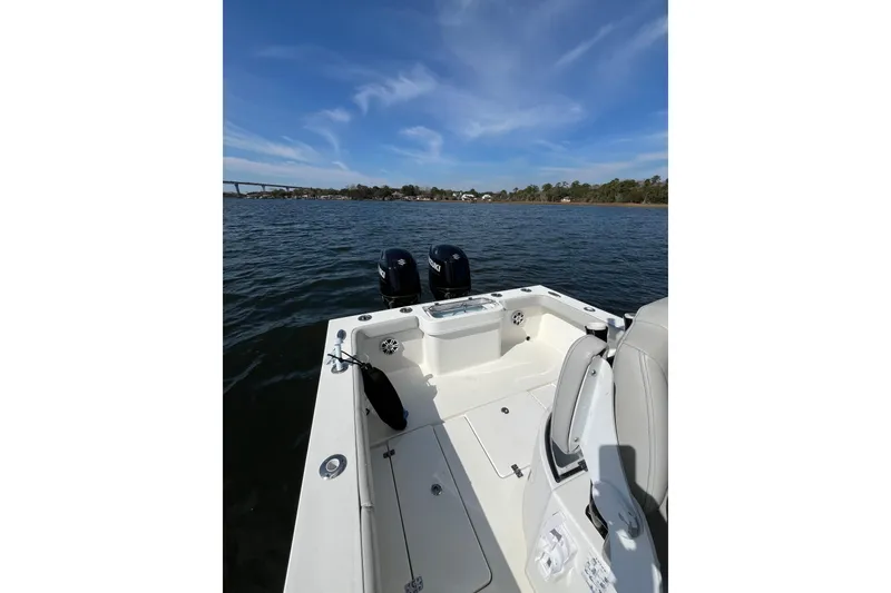 Slide: The Image of 2023 Pair Customs 24 Center Console DV boat on water, featuring dual engines. - 18