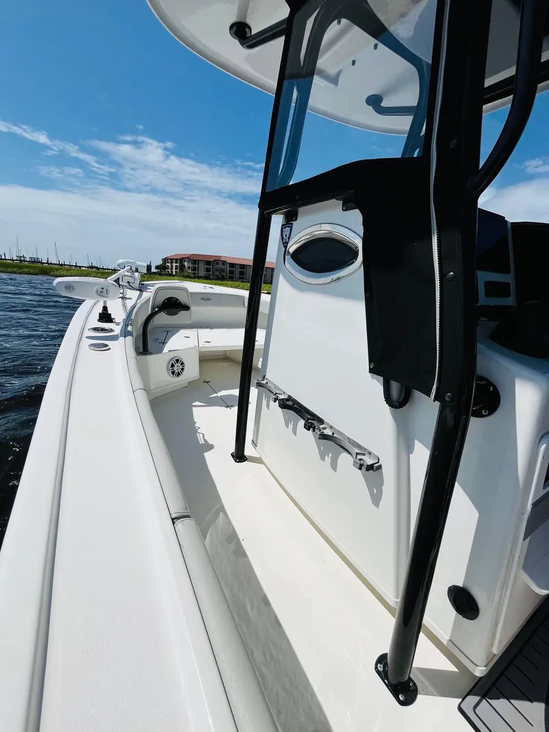 Slide: The Image of 2023 Pair Customs 24 Center Console DV boat interior with steering wheel and control panel. - 4