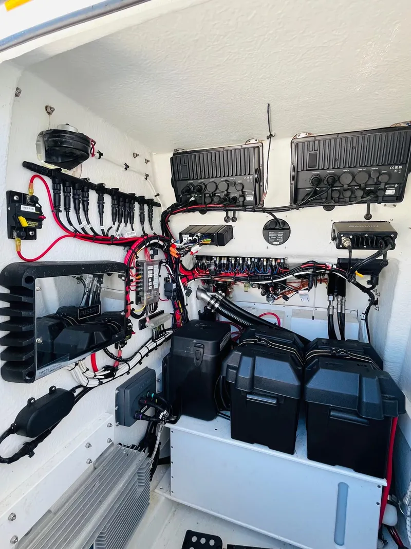 Slide: The Image of 2023 Pair Customs 24 Center Console DV boat interior with cushioned seating and speakers. - 9