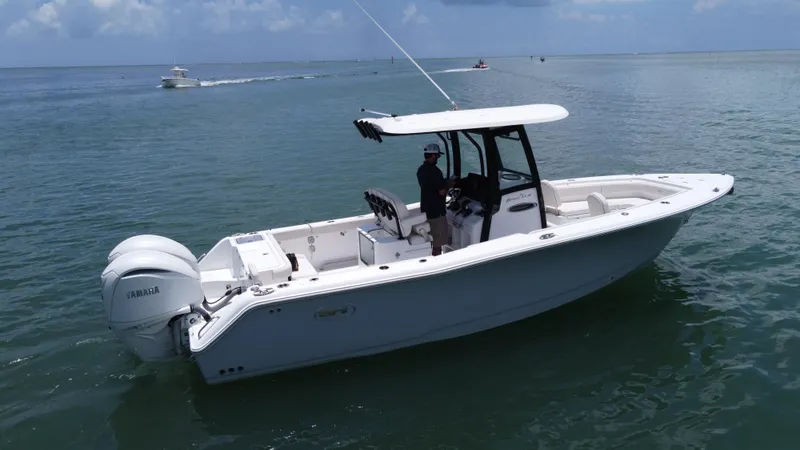 The Image of 2024 Sea Hunt Gamefish 27 Forward Seating boat on calm ocean waters. - 0