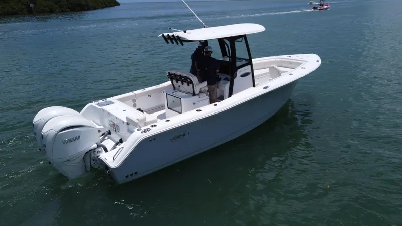 Slide: The Image of 2024 Sea Hunt Gamefish 27 boat with forward seating on calm water. - 10