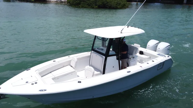 Slide: The Image of 2024 Sea Hunt Gamefish 27 boat with forward seating on calm water. - 11