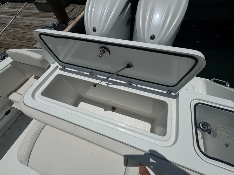 Slide: The Image of 2024 Sea Hunt Gamefish 27 Forward Seating boat with open storage compartment. - 19