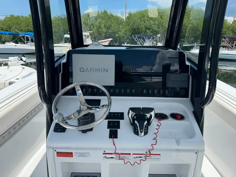 Slide: The Image of 2024 Sea Hunt Gamefish 27 helm with Garmin display and steering wheel. - 22