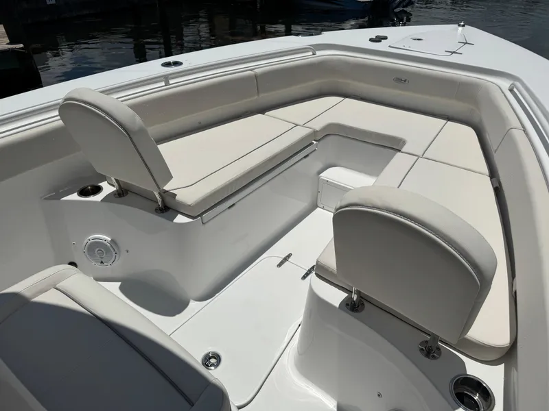 Slide: The Image of 2024 Sea Hunt Gamefish 27 Forward Seating with cushioned seats and storage compartments. - 28
