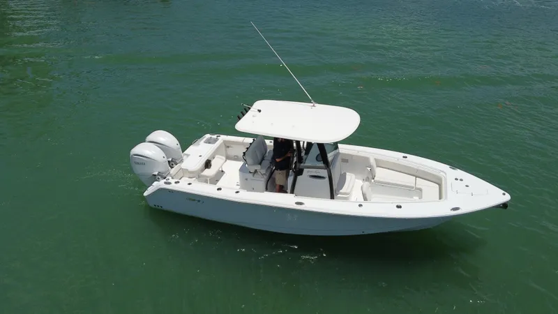 Slide: The Image of 2024 Sea Hunt Gamefish 27 boat with forward seating on calm water. - 8