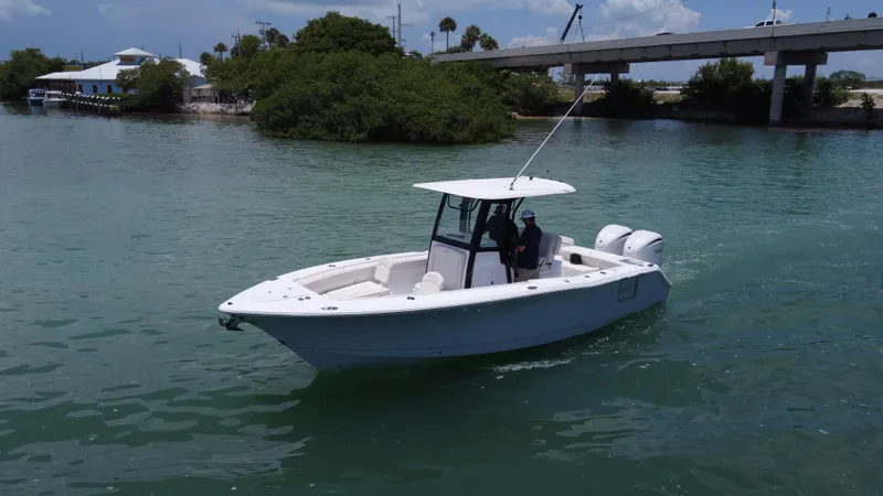 Slide: The Image of 2024 Sea Hunt Gamefish 27 boat cruising on a calm waterway. - 9