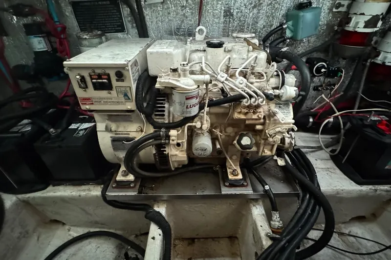 Slide: The Image of Engine compartment of a 2006 Rinker 300 Express Cruiser with visible wiring and components. - 13
