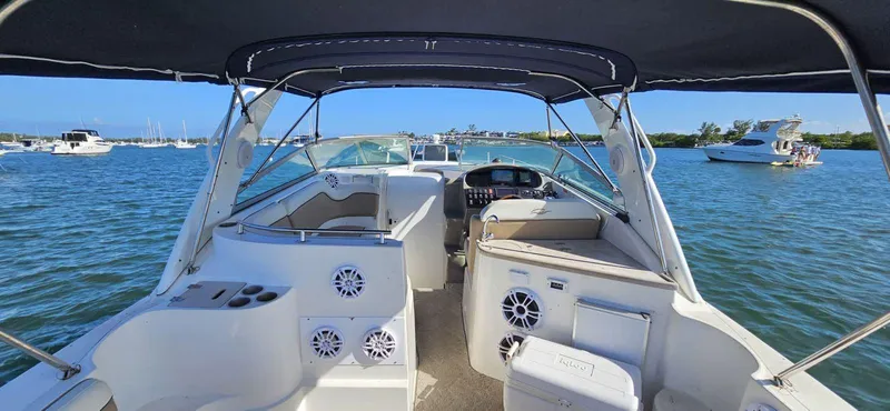 Slide: The Image of 2006 Rinker 300 Express Cruiser interior view on a sunny day at sea. - 5