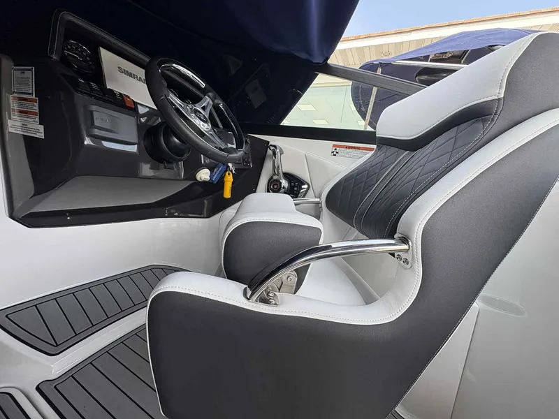 Slide: The Image of 2023 Monterey M65 boat interior with steering wheel and cushioned seating. - 14