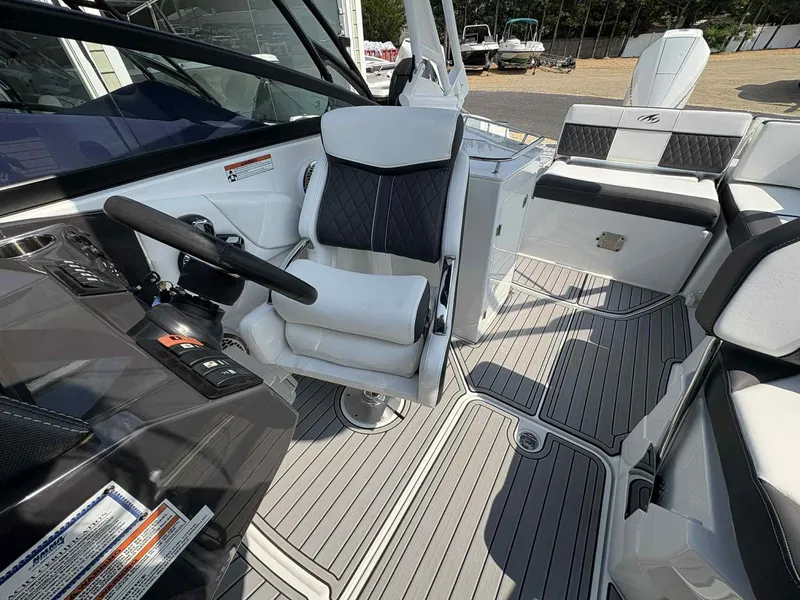 Slide: The Image of 2023 Monterey M65 boat interior with sleek seating and modern steering console. - 15