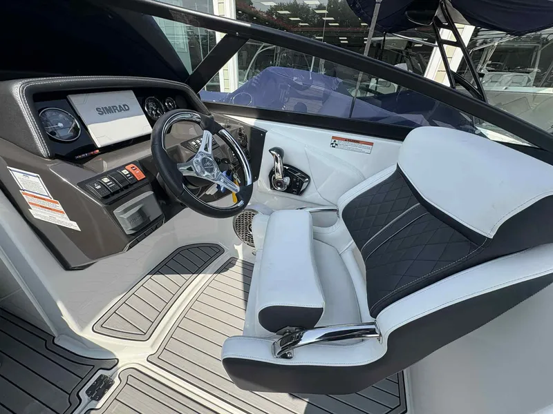 Slide: The Image of 2023 Monterey M65 boat cockpit with steering wheel and modern dashboard. - 16