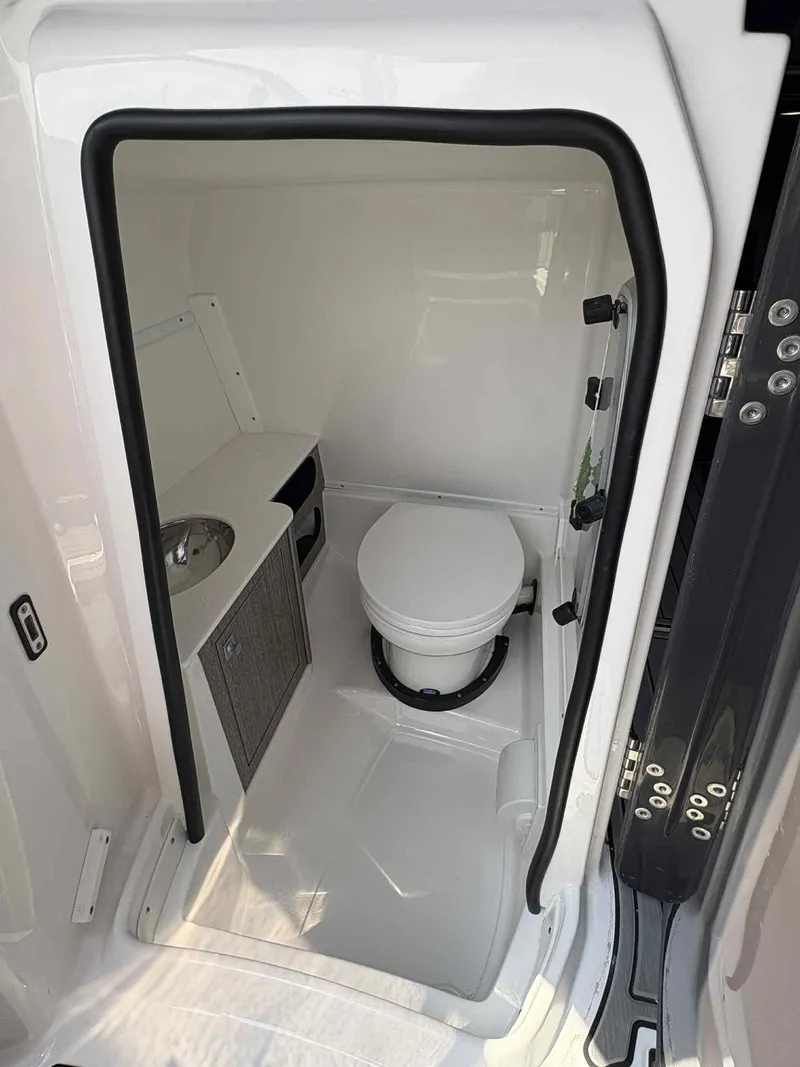 Slide: The Image of Compact bathroom in 2023 Monterey M65 boat with toilet and sink. - 18
