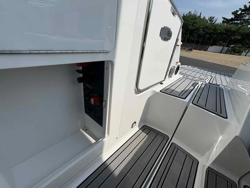 Slide: The Image of 2023 Monterey M65 boat deck with storage compartment and sleek design. - 22