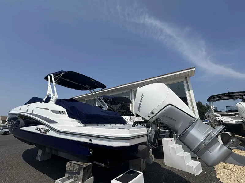 Slide: The Image of 2023 Monterey M65 boat with Mercury engine displayed outdoors. - 3